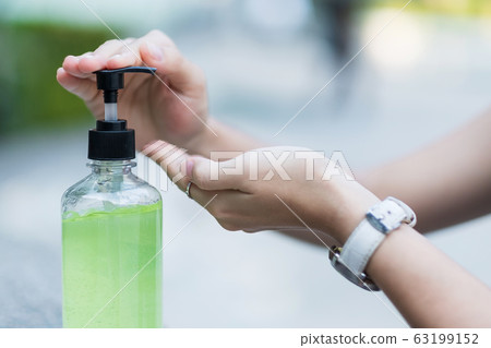 Woman hands using wash hand sanitizer gel Woman hands using wash hand sanitizer gel 63199152