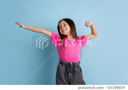 Caucasian little girl's portrait on blue studio background 63199854