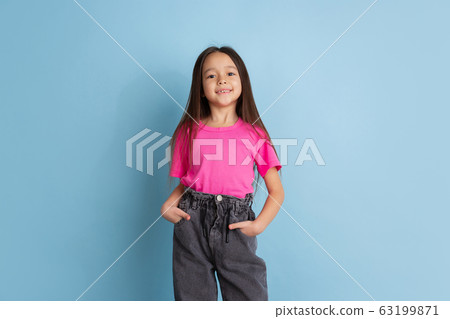 Caucasian little girl's portrait on blue studio background 63199871