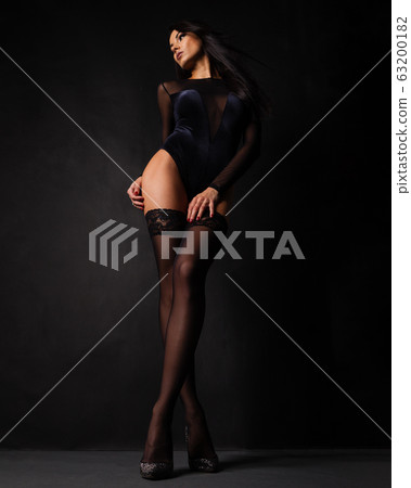 woman in lingerie bodysuit and stockings posing 63200182