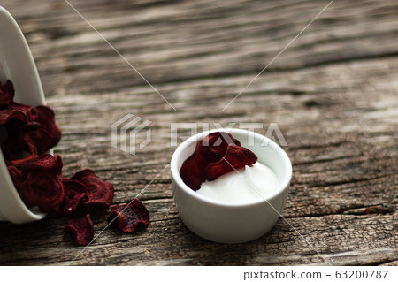Beetroot Chips. Useful handmade vegetable snack. In a dish are pieces of root vegetables. Garlic, rosemary and sauce in a dish bowl. Soft focus 63200787