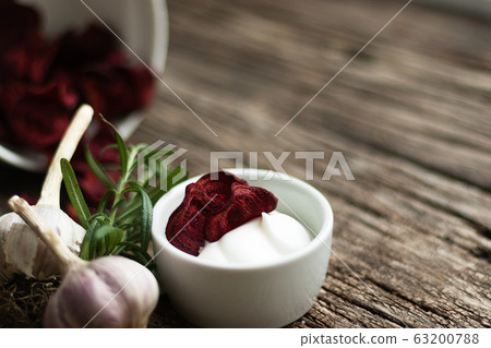 Beetroot Chips. Useful handmade vegetable snack. In a dish are pieces of root vegetables. Garlic, rosemary and sauce in a dish bowl. Soft focus 63200788