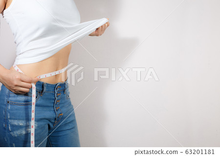 Healthcare and woman diet lifestyle concept to reduce belly and shape up healthy stomach muscle. 63201181