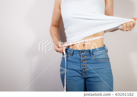 Healthcare and woman diet lifestyle concept to reduce belly and shape up healthy stomach muscle. 63201182