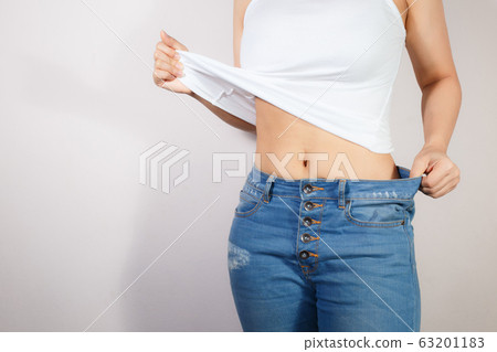 Healthcare and woman diet lifestyle concept to reduce belly and shape up healthy stomach muscle. Healthcare and woman diet lifestyle concept to reduce belly and shape up healthy stomach muscle. 63201183