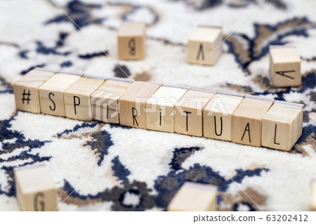 Wooden cubes with a hashtag and the word Spiritual, social media and spiritual concept background 63202412