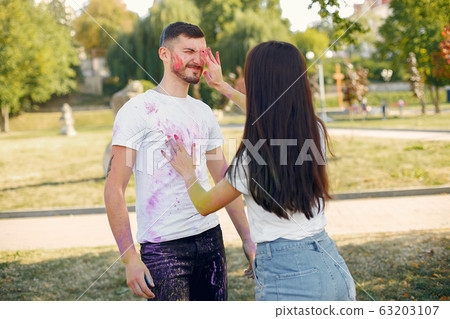 People have fun in a park with holi paints 63203107