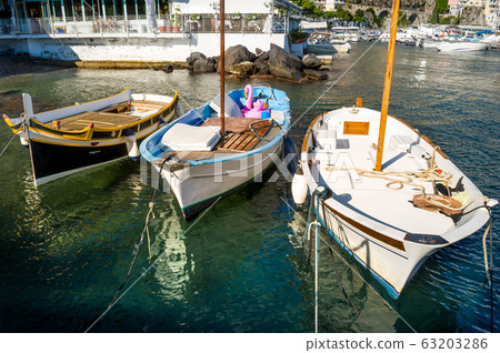 Old boats of local fishermans in Amalfi marina Old boats of local fishermans in Amalfi marina 63203286