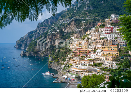 View from palm tree branches to Positano village 63203309