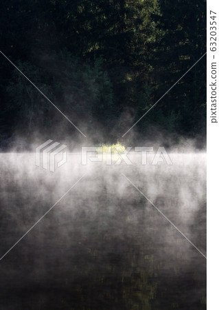 Morning haze over surface of the Pohorsky pond know as Jiricka reservoir near Pohorska Ves, Novohradske Mountains, Cesky Krumlov District, South Bohemian Region, Czech Repubic Morning haze over surface of the Pohorsky pond know as Jiricka reservoir near Pohorska Ves, Novohradske Mountains, Cesky Krumlov District, South Bohemian Region, Czech Repubic 63203547