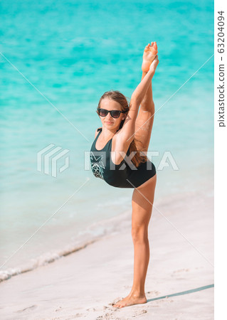Adorable active little girl at beach during summer vacation 63204094