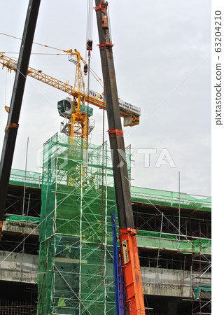 Construction workers working at height at the construction site. They are requested to wear appropriate safety gear to prevent bad happen to them.  63204210