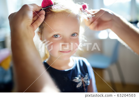 Young handsome father making cute hairstyle for Young handsome father making cute hairstyle for 63204503