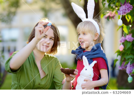 Family celebrate Easter holiday in spring park. Family celebrate Easter holiday in spring park. 63204669