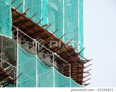 Catch platform or other construction projection from the face of a building. It is protect individuals and property from falling debris during construction. Catch platform or other construction projection from the face of a building. It is protect individuals and property from falling debris during construction. 63204821