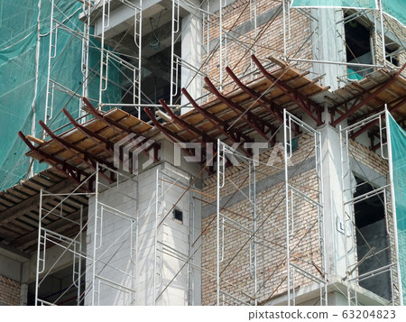 Catch platform or other construction projection from the face of a building. It is protect individuals and property from falling debris during construction. Catch platform or other construction projection from the face of a building. It is protect individuals and property from falling debris during construction. 63204823