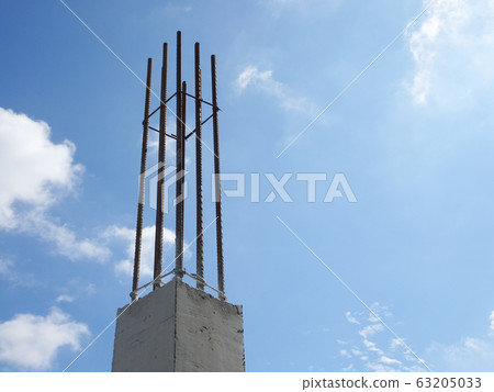 Reinforcement concrete column as part of building structure at the construction site. Reinforcement bar on top of column ready for next stage of construction. 63205033