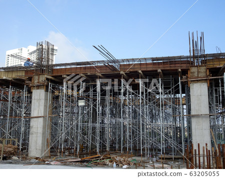 Reinforcement concrete column as part of building structure at the construction site. Reinforcement bar on top of column ready for next stage of construction. 63205055