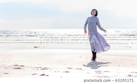 A healthy middle woman playing on the sandy beach Healthy image 63205171
