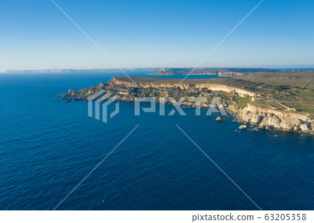 Aerial drone view of rocky coastline and sea. Aerial drone view of rocky coastline and sea. 63205358