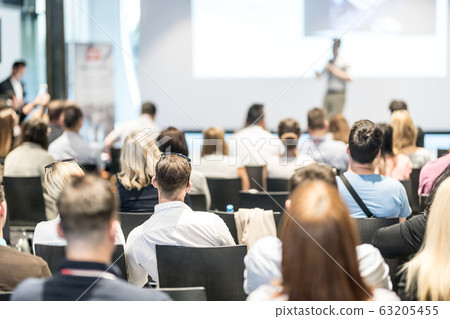 Male business speaker giving a talk at business conference event. 63205455