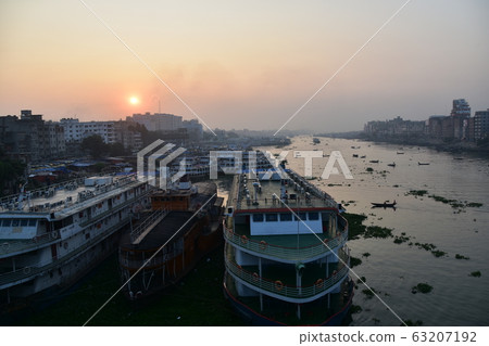 Dhaka, Bangladesh Beautiful sunrise and old town Passenger boats stopping along the Brigonga Boats crossing the river 63207192