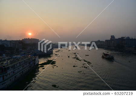 Dhaka, Bangladesh Beautiful sunrise and old town Passenger boats stopping along the Brigonga Boats crossing the river 63207219