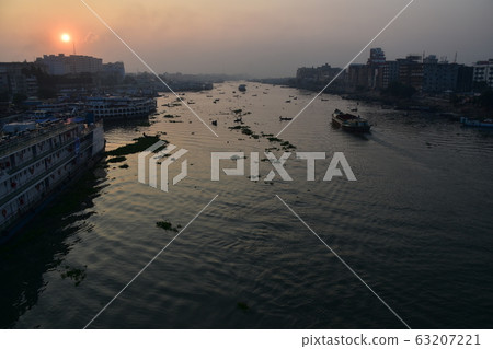 Dhaka, Bangladesh Beautiful sunrise and old town Passenger boats stopping along the Brigonga Boats crossing the river 63207221