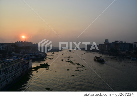 Dhaka, Bangladesh Beautiful sunrise and old town Passenger boats stopping along the Brigonga Boats crossing the river 63207224