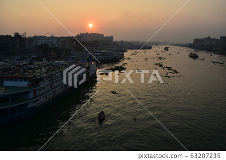 Dhaka, Bangladesh Beautiful sunrise and old town Passenger boats stopping along the Brigonga Boats crossing the river 63207235