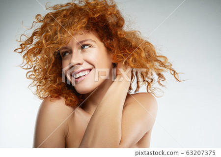 Positive delighted female person posing on camera 63207375