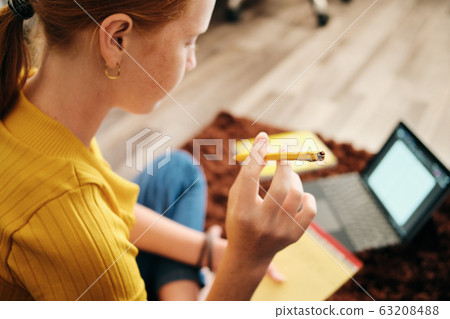 Preteen Redhead Girl Studying At Home And Biting Pencil Preteen Redhead Girl Studying At Home And Biting Pencil 63208488