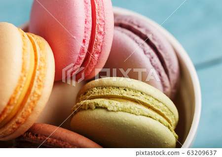 Macaroni cookies in a white plate, on a blue 63209637