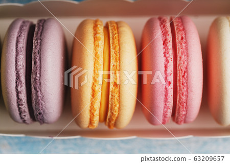 Macaroni cookies of different colors in a box on a Macaroni cookies of different colors in a box on a 63209657