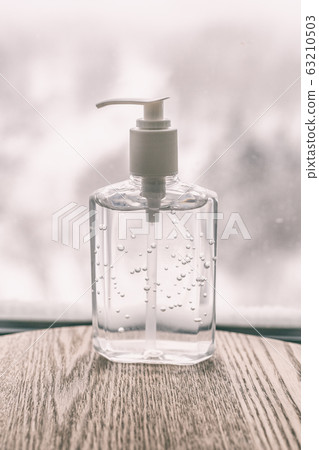 Coronavirus hand sanitizer cleaning gel for washing hands against germs and flu virus. Alcohol based antimicrobial disinfectant product for airport, hospital, healthcare and home 63210503