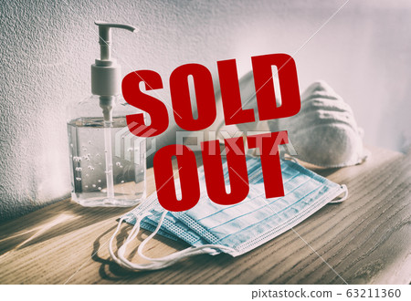 Coronavirus panic buying shopping shortage of sanitizing products hand sanitizer gel bottles, masks, healthcare supply stockpiling problem . Sign showing SOLD OUT in red text 63211360