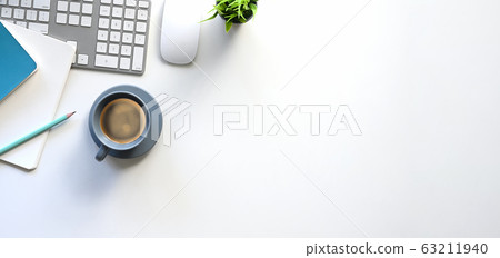 Top view of white working table with office equipment putting on it. 63211940