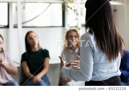 Corporate staff gathered together listening business coach at seminar Corporate staff gathered together listening business coach at seminar 63212218