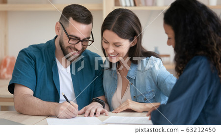 Happy family couple signing contract with agent. Happy family couple signing contract with agent. 63212450