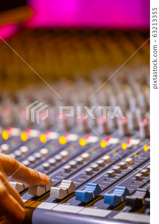 sound engineer fingers adjusting on audio mixing console fader. recording, broadcasting concept 63213355