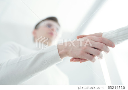 People in white making handshake 63214510