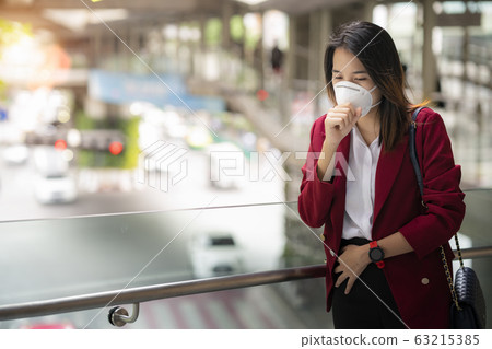 Asian girl use a protection mask for prevent PM 63215385