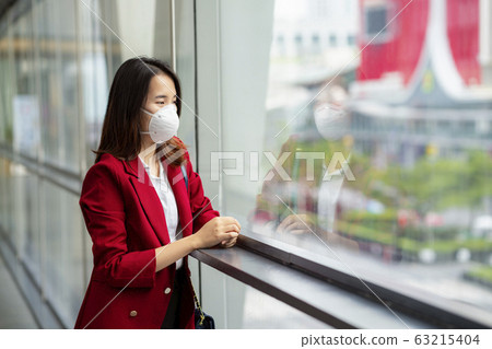 Asian girl use a protection mask for prevent PM 63215404