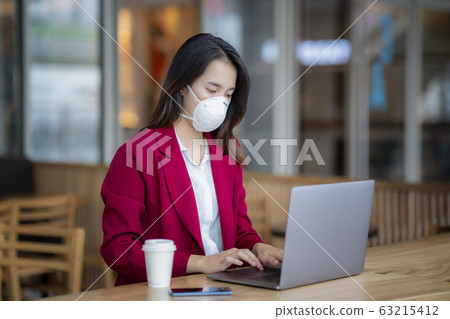 Asian girl use a protection mask for prevent PM 63215412