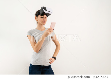 Girl in VR glasses isolated on white background. Extended reality  63215637