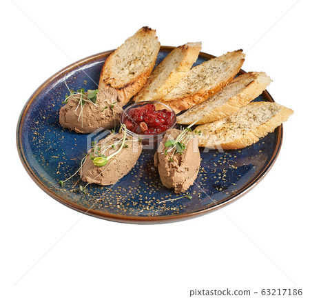 Chicken liver pate with crunchy baguette and fruit jelly sauce isolated on white background. Delicious duck or goose liver spread or foie with croutons on elegant restaurant blue plate Chicken liver pate with crunchy baguette and fruit jelly sauce isolated on white background. Delicious duck or goose liver spread or foie with croutons on elegant restaurant blue plate 63217186