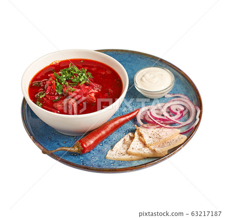 Homemade Russian, Ukrainian national soup, red borscht made of beetrot with pork ribs, close-up, isolated on white background. With clipping path. 63217187