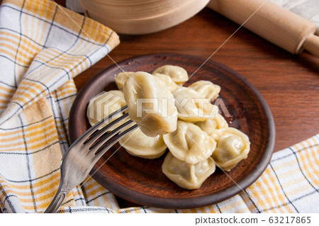 Close up view of boiled meat dumpling on metal 63217865