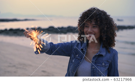 Holiday concept. A beautiful woman playing Holiday concept. A beautiful woman playing 63217966