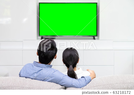 Back view of Asian couple sitting on sofa relaxing 63218172